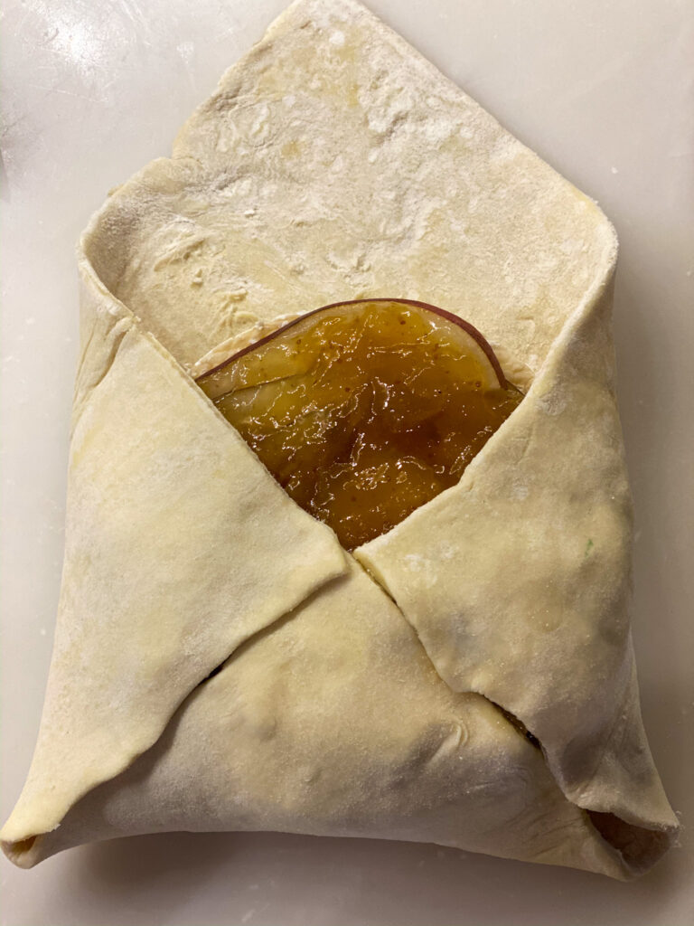 folding puff pastry over top of brie