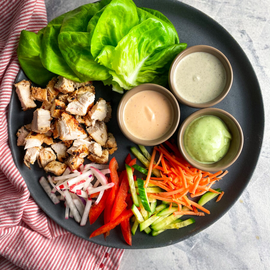 Grilled chicken, sliced cold veggies, 3 yogurt sauces and lettuce.