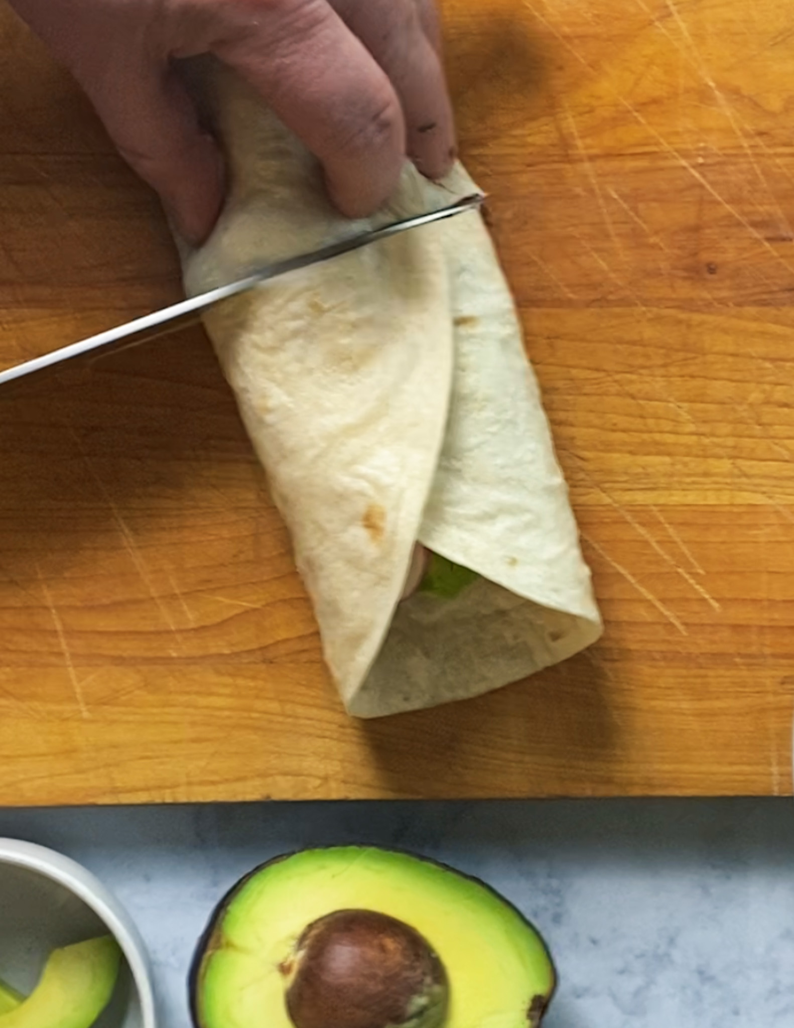 slicing the baja fish burrito in half