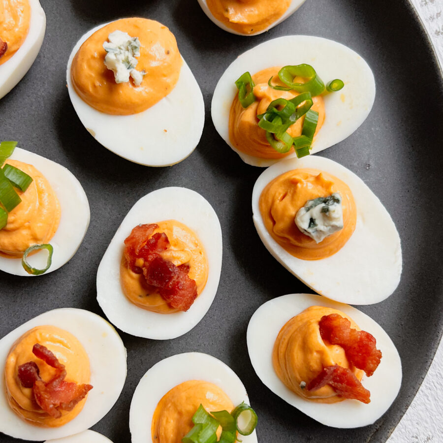 Spicy Deviled Eggs with bleu cheese, green onions and bacon on top
