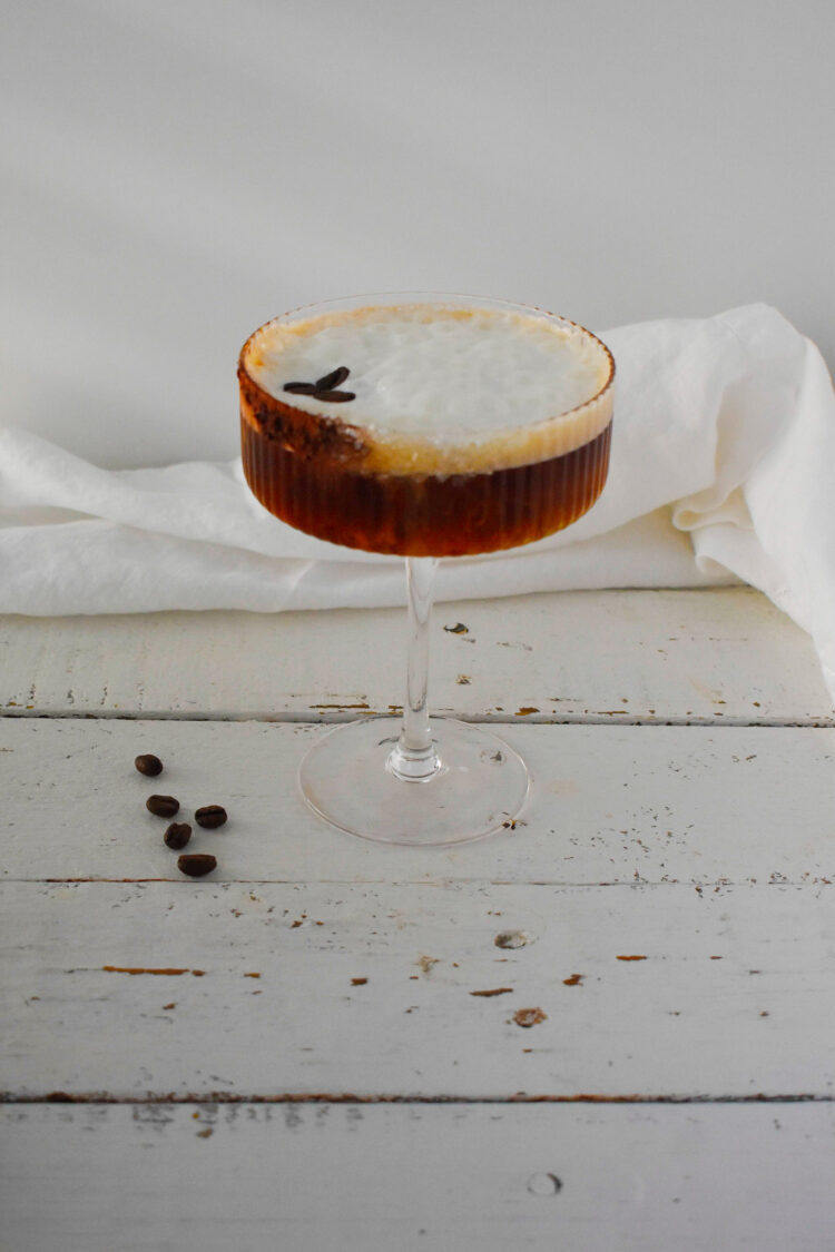 Hazelnut Espresso Martini with coffee beans on top and on the side