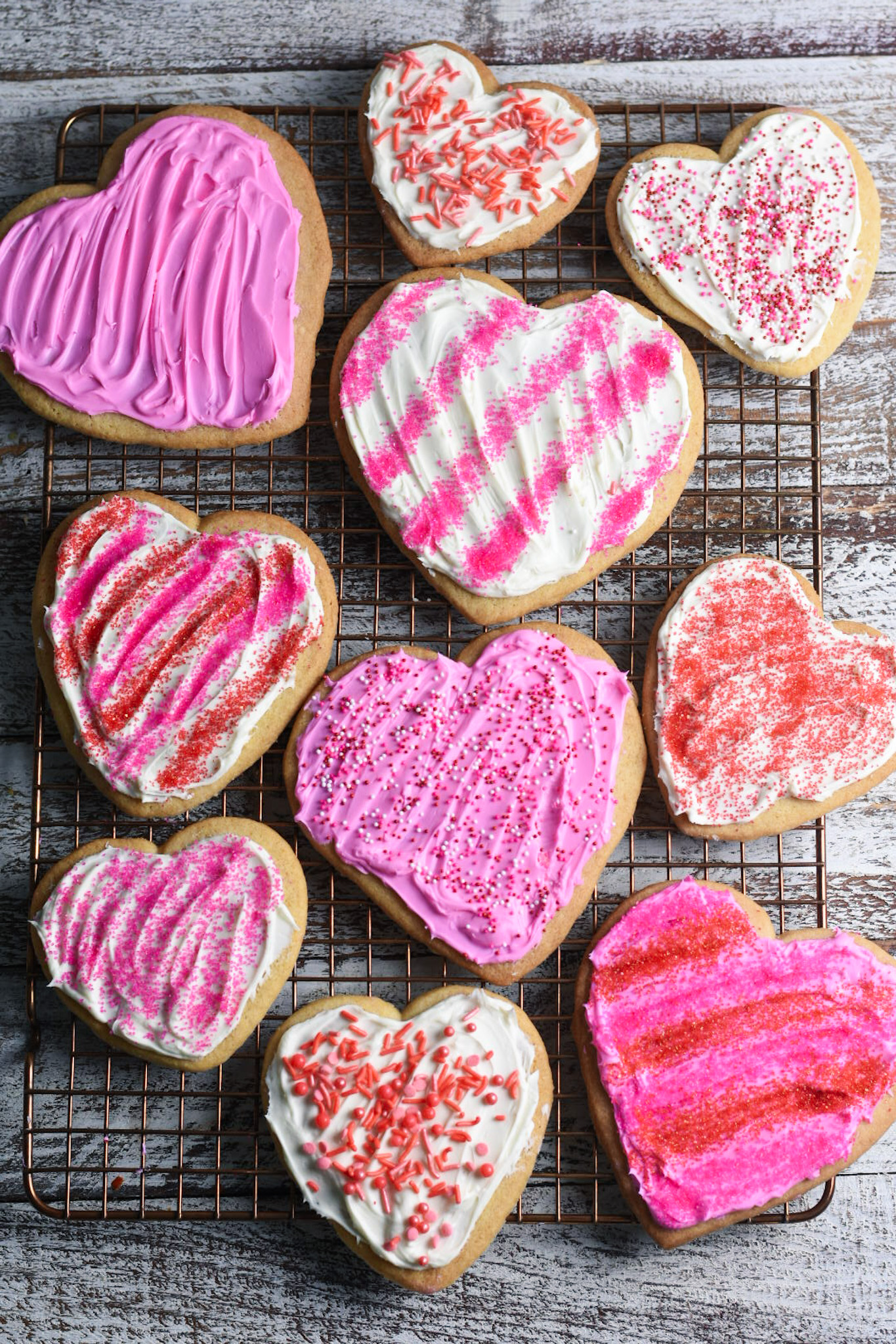 Heart shaped sugar cookies with pin frosting and sprinkles