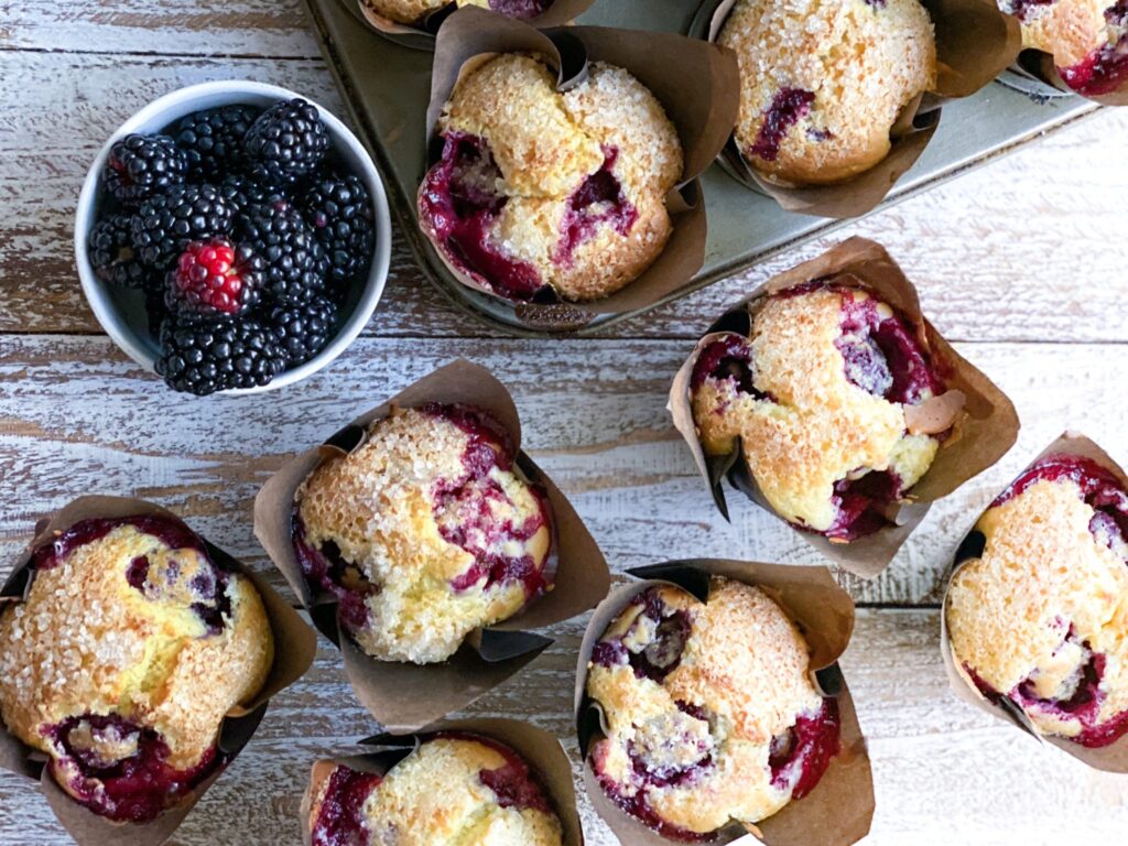 blackberry muffins and a bowl of blackberries