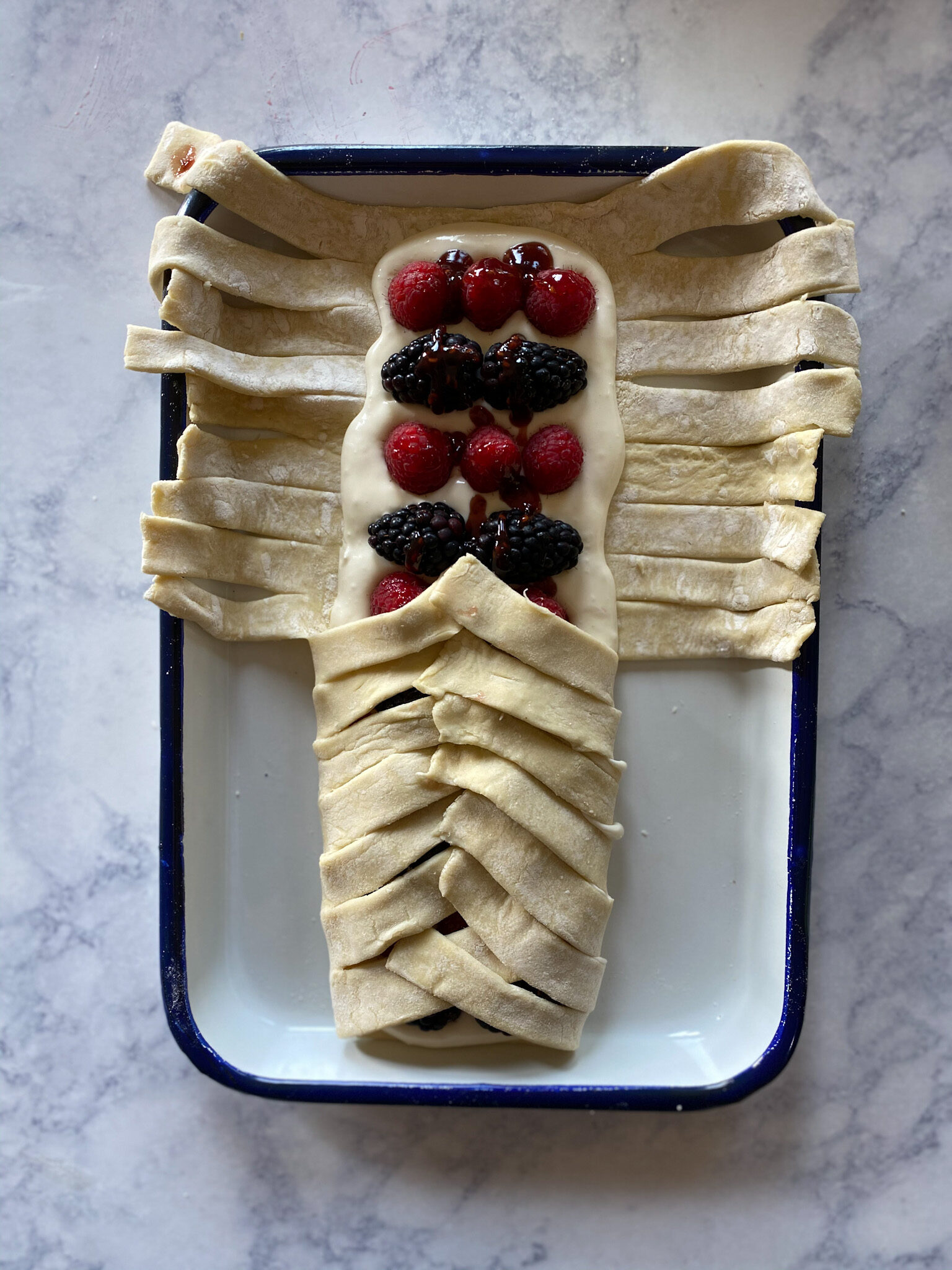 puff pastry being folded over berries