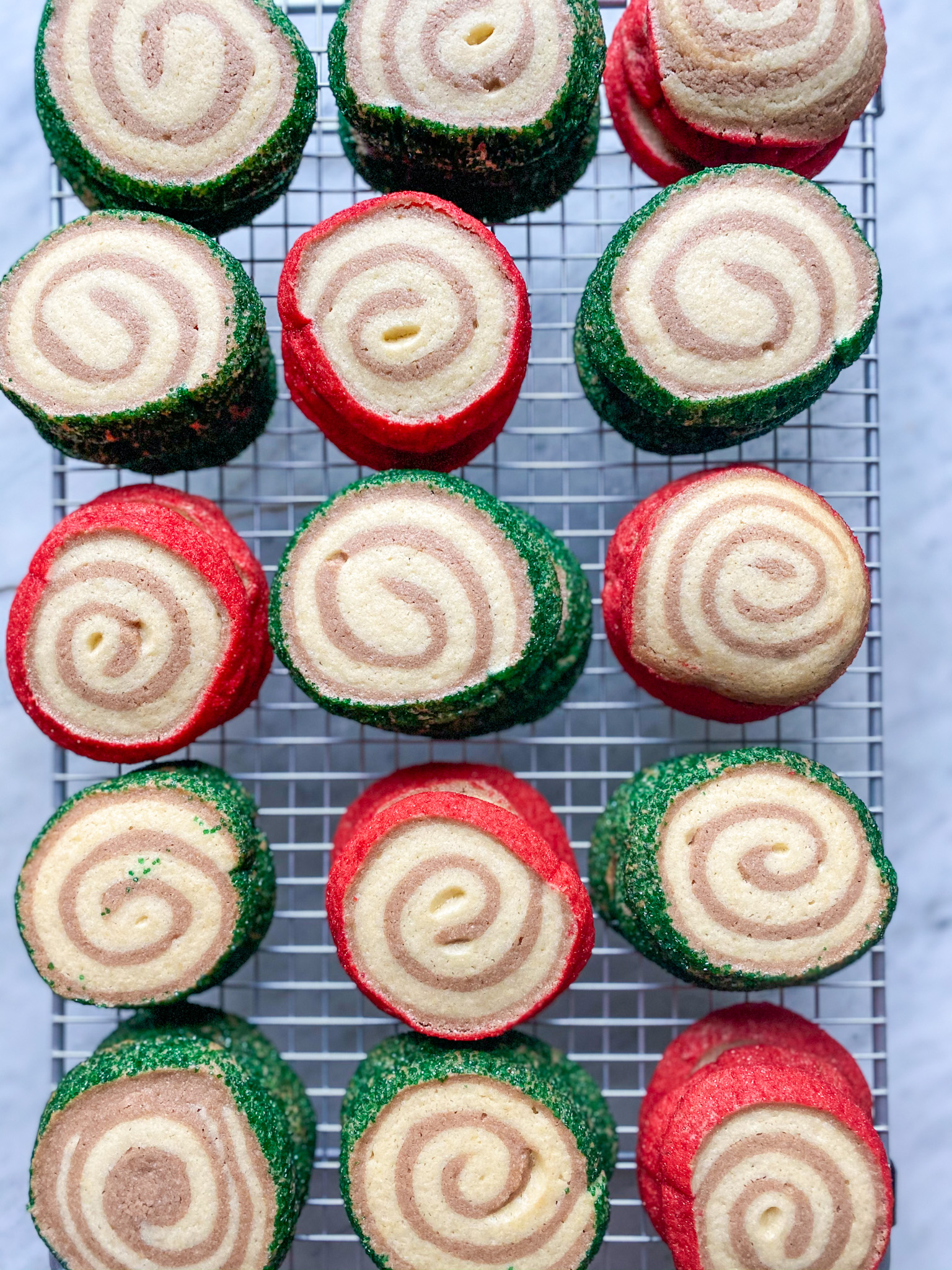 red and green pinwheel cookies and a cookie rack