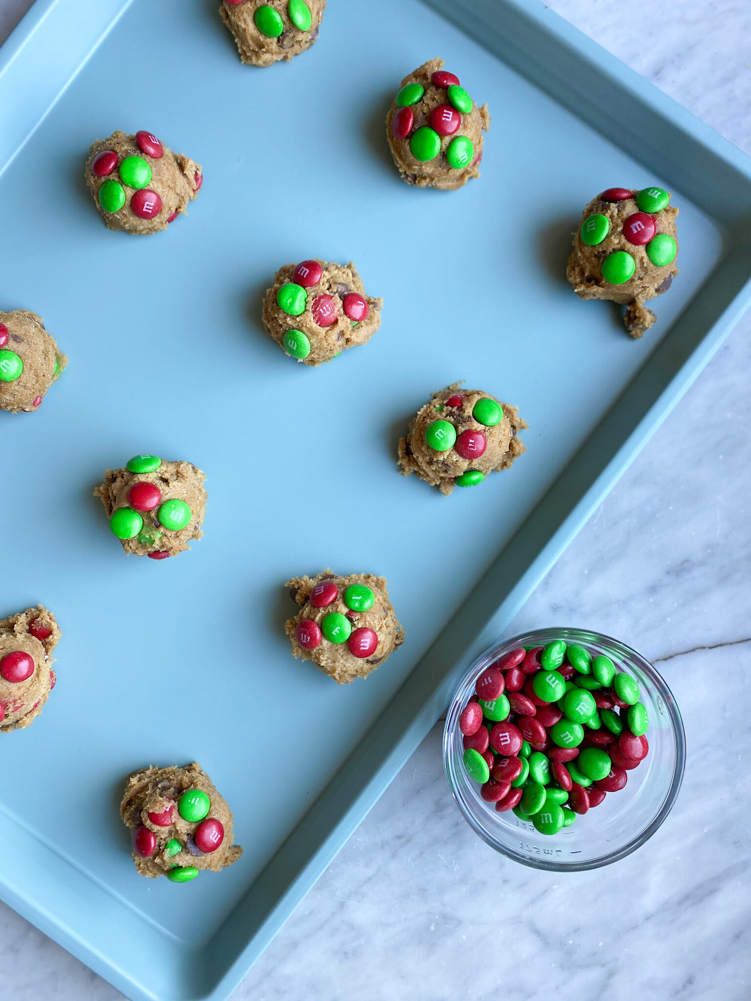 pan of M&M covered chocolate chip cookie balls