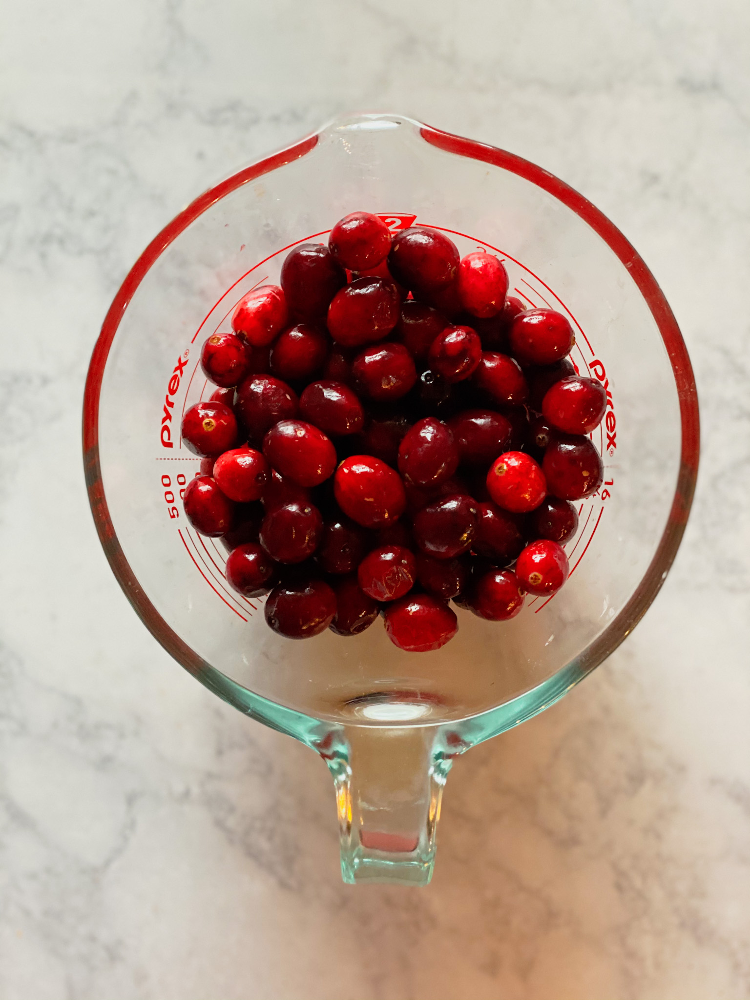 cranberries in a pyrex measuring cup