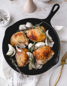Valentines Day Dinner of Chicken thighs in a cast iron skillet with rosemary