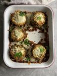 crispy eggplant parm stacks in a pan with one missing