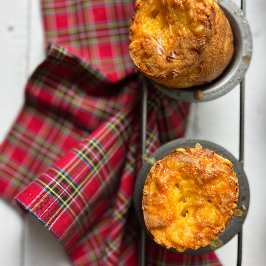 2 Double Cheddar Cheese popovers and a red plaid napkin