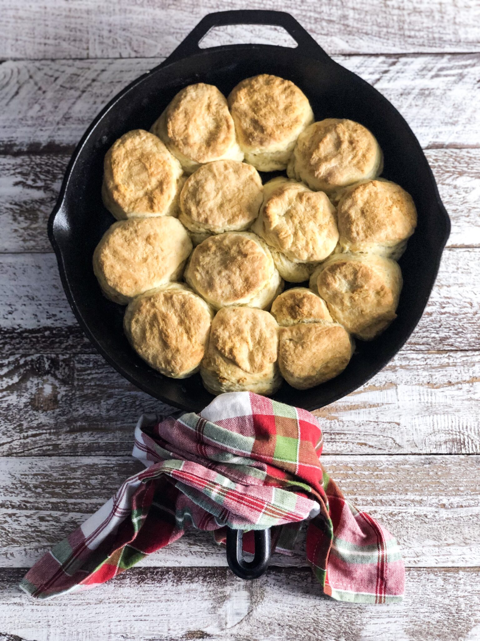 biscuits in a cast iron pan and a red and green napkin
