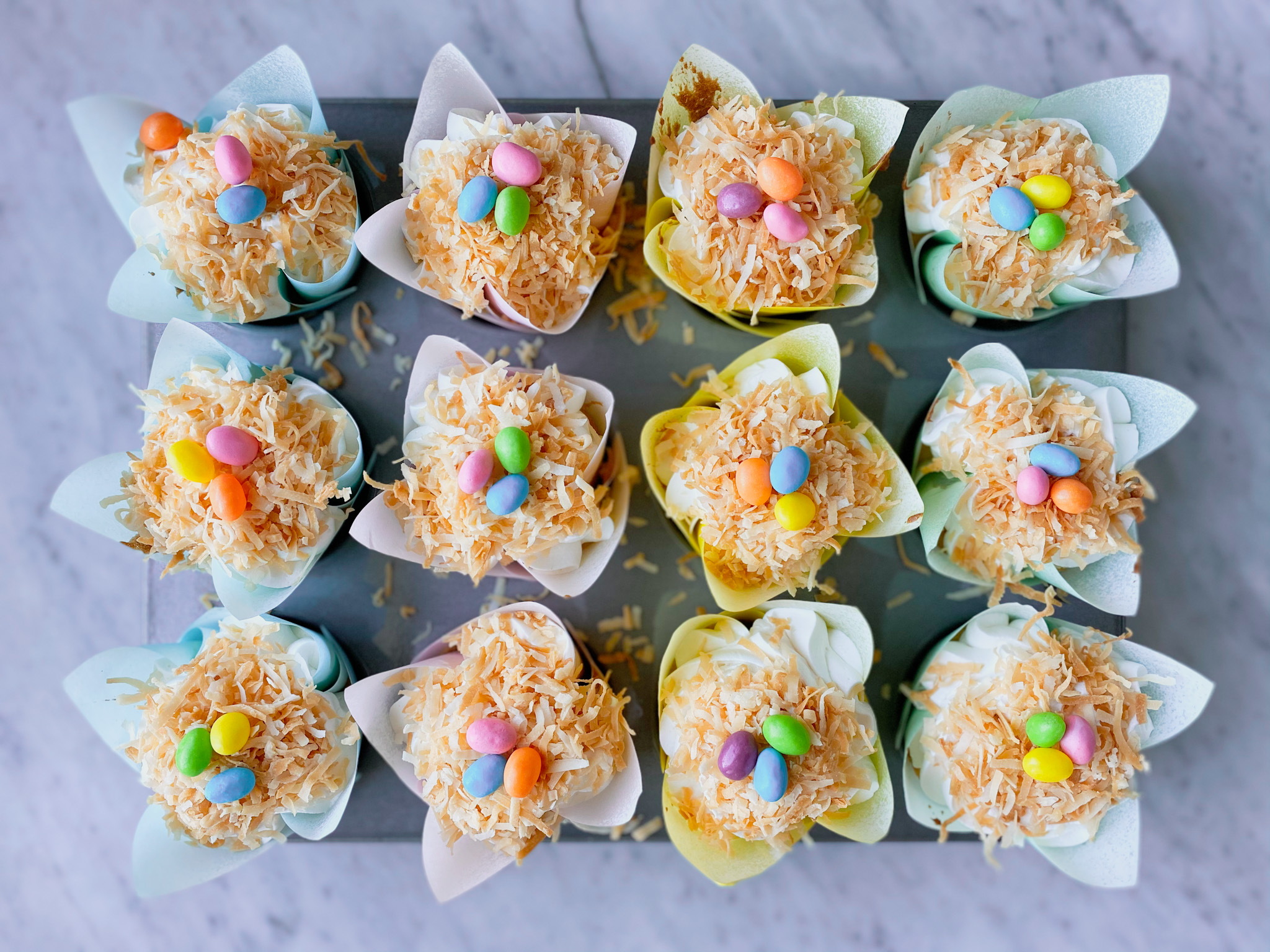 Toasted coconut and jelly bean topped coconut cream cupcakes