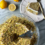 Lemon bundt cake with a slice of cake and some lemons