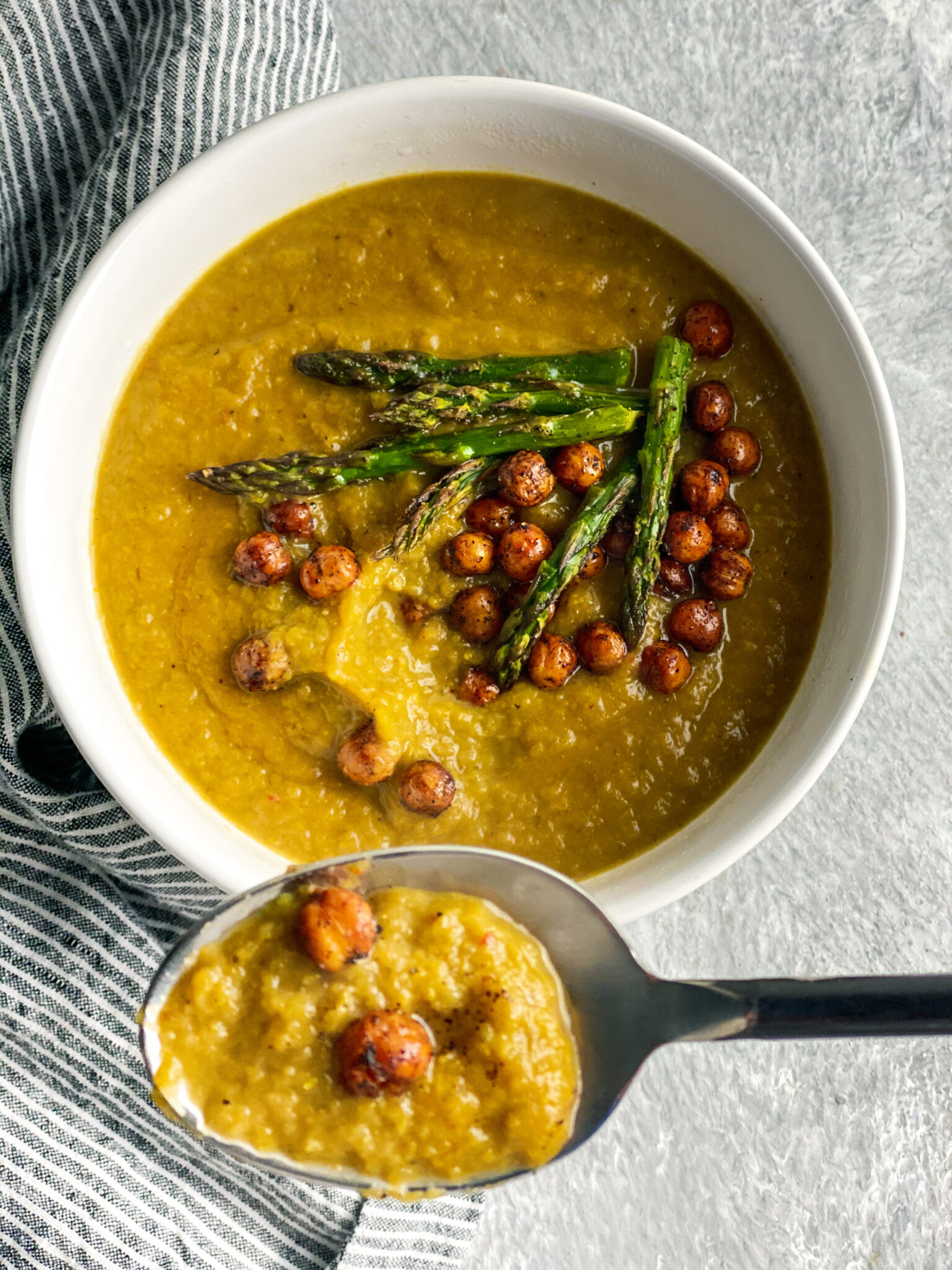 Asparagus soup with garbanzo beans and a spoon of soup