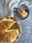 Coconut cream pie with a slice out of it on a plate