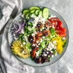 Cucumbers, tomatoes, pepperoncinis, calamita olives, avocado, red onions, shrimp salad.