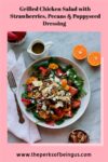 Grilled chicken spinach salad with strawberries, oranges, pecans and poppyseed dressing.