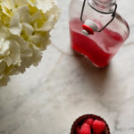 Raspberry Simple syrup, raspberries, and a white flower