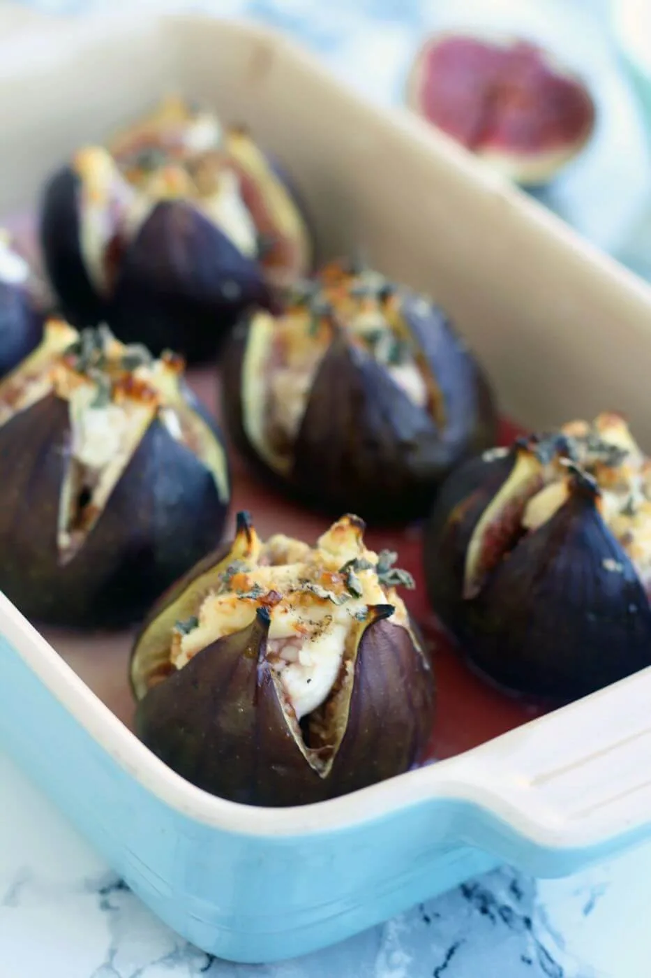 baked figs with goat cheese in a pan