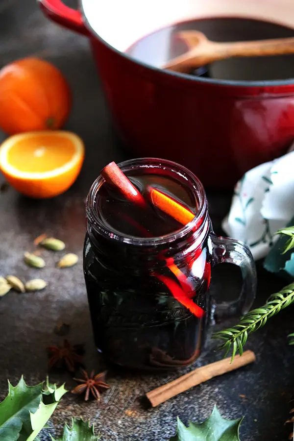 German mulled wine in a mason mug with cinnamon stick and orange slices