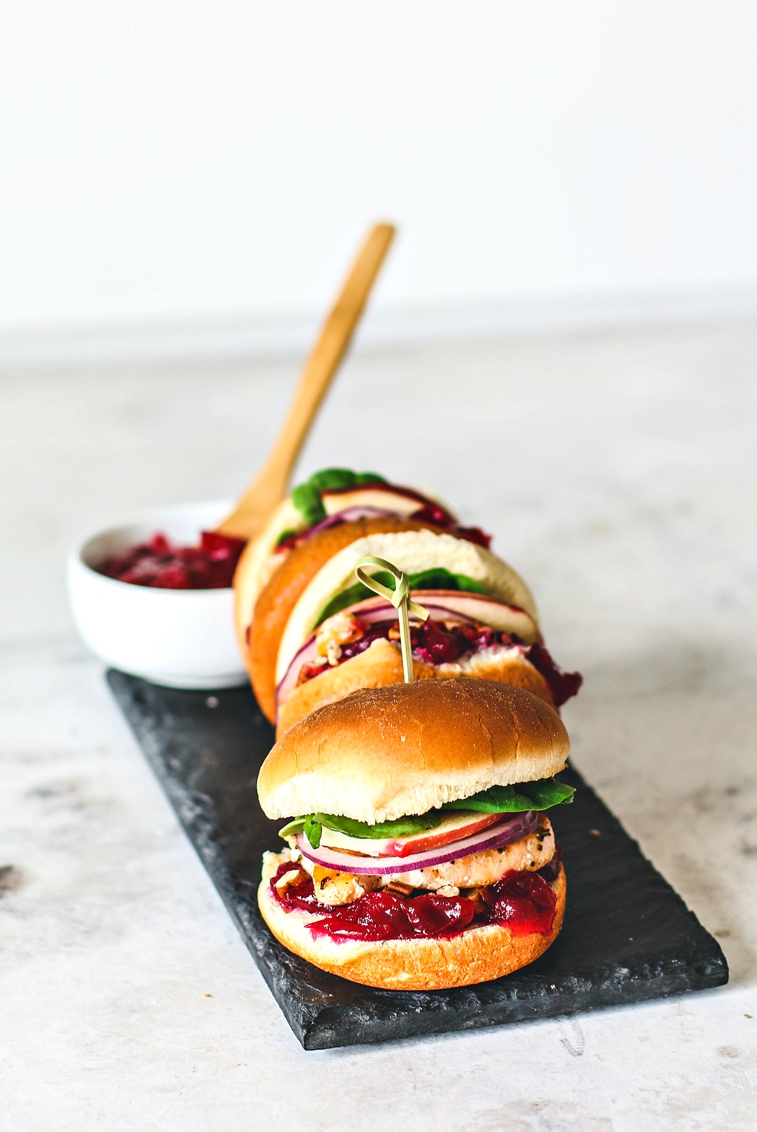 Salmon sliders with cranberry sauce on a platter