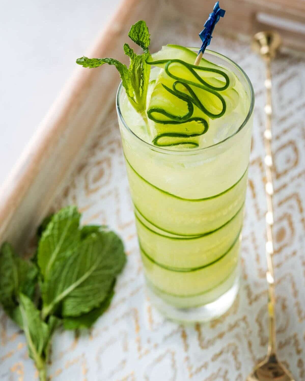 cucumber cocktail in a tall glass with cucumber garnish