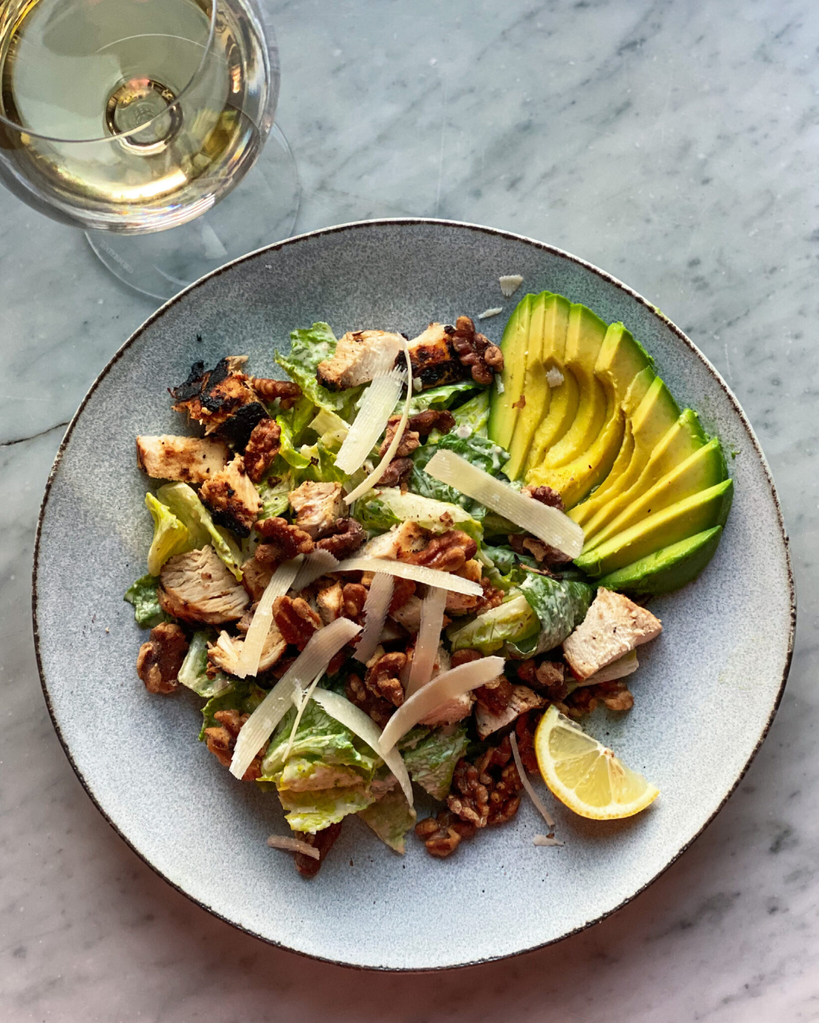Caesar salad with avocado and walnuts and chicken