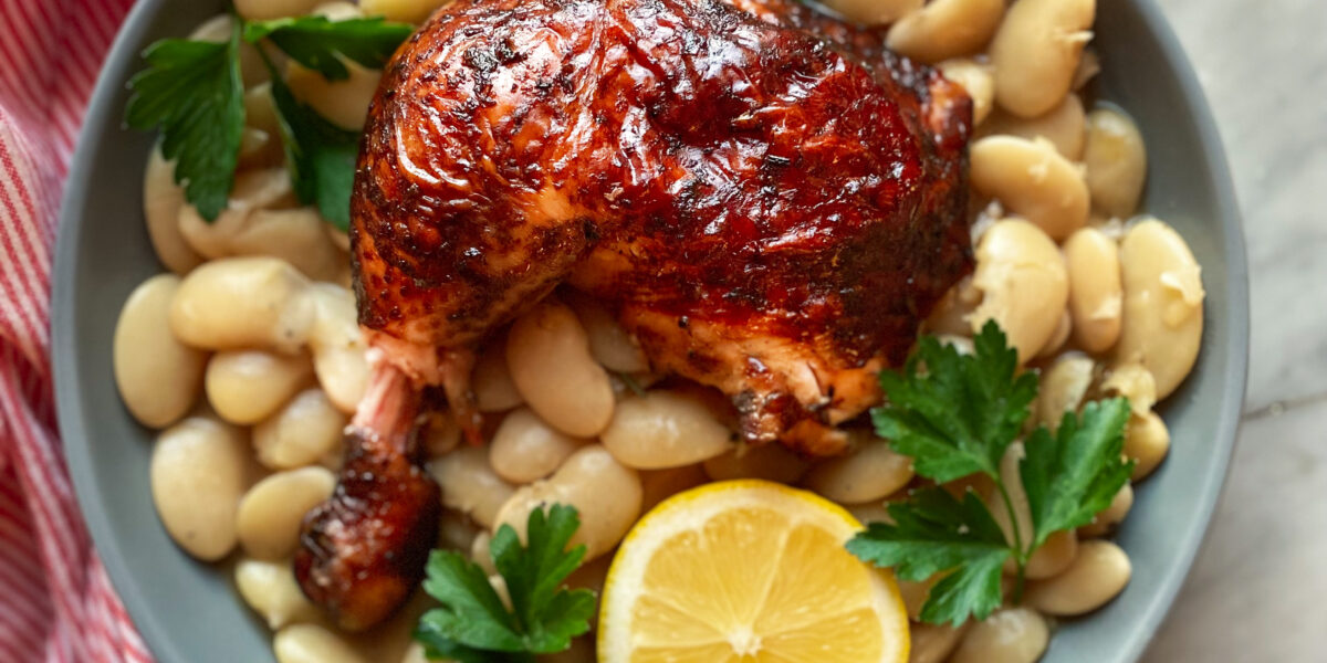 beer can smoked chicken with beans and a lemon