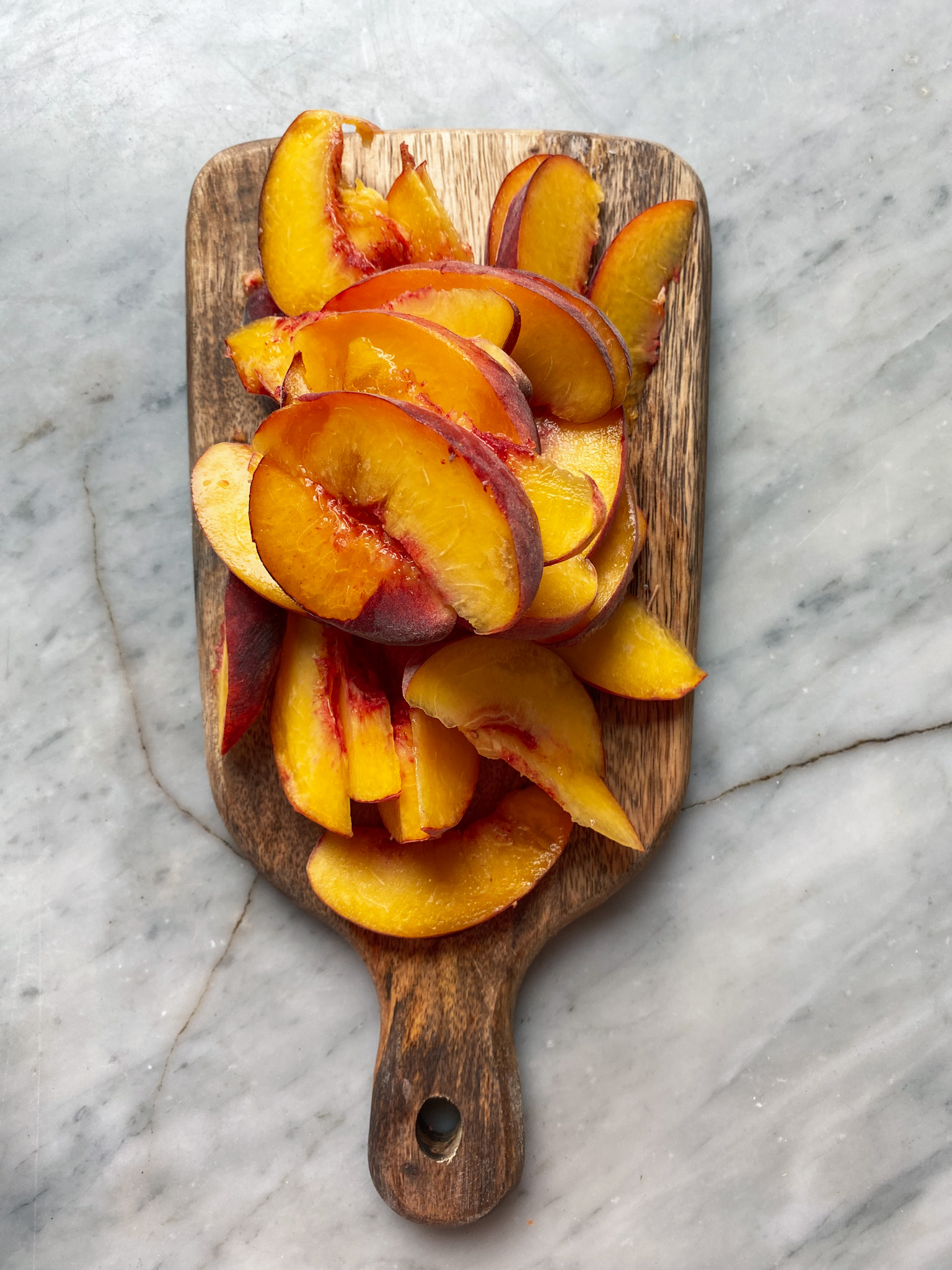 sliced peaches on a cutting board