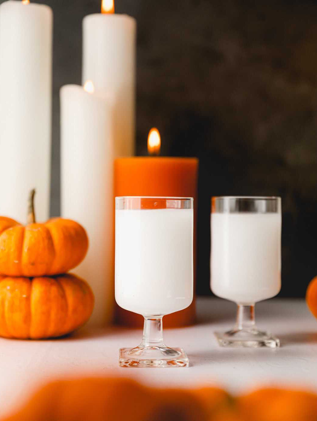 white as a ghost cocktails with candles and pumpkins
