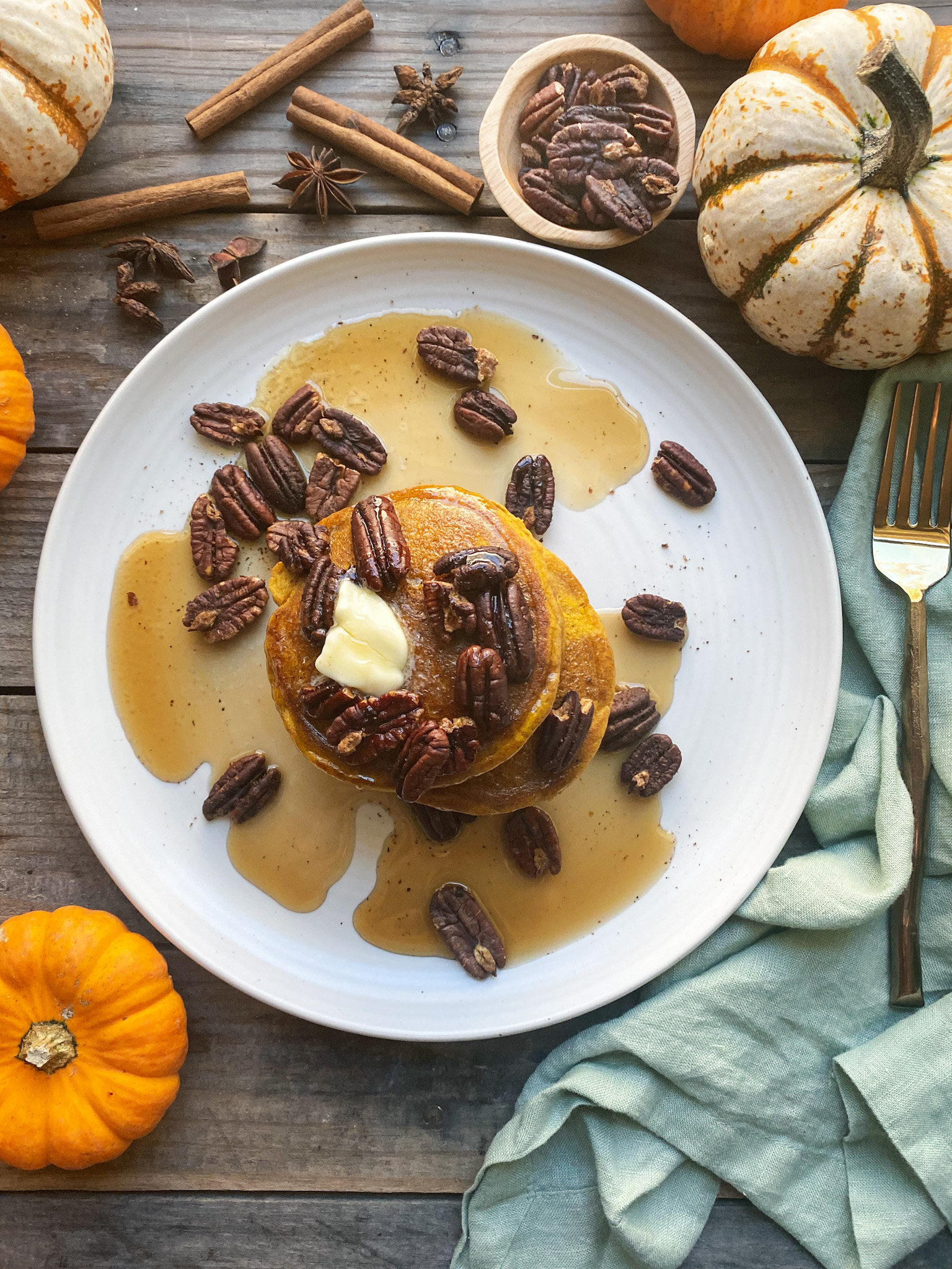 pumpkin pancakes with pecans and maple syrup