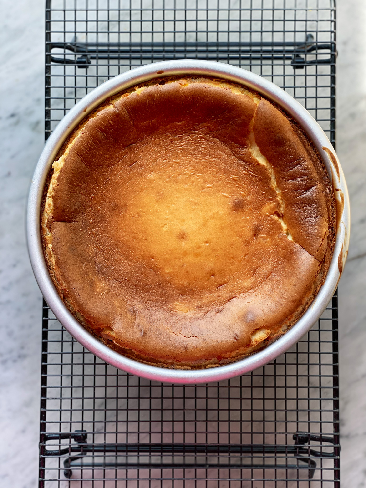baked cheesecake on a cooling rack