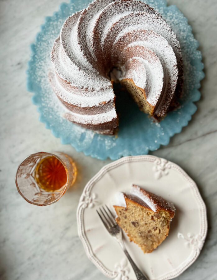bourbon butter pecan cake with a slice and a glass of bourbon