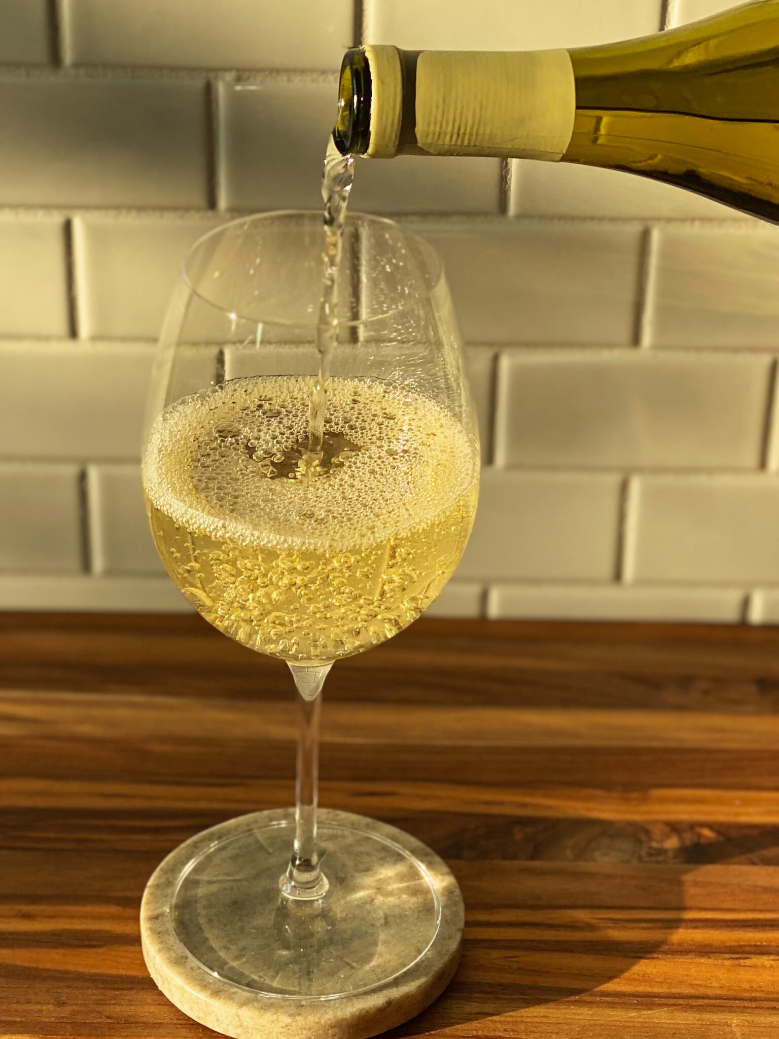 white wine being poured into a glass