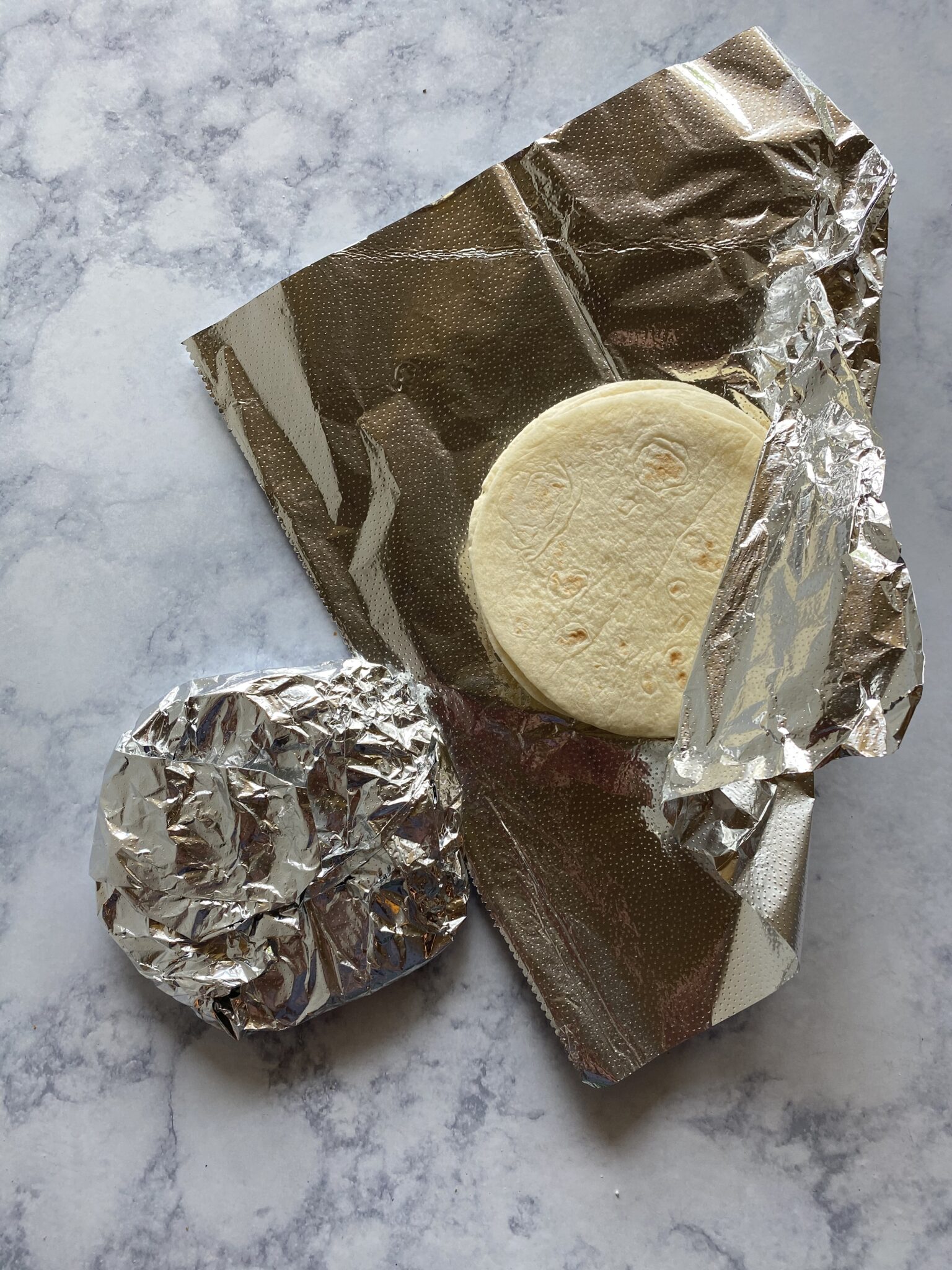 mini flour tortillas in foil, one opened and one closed