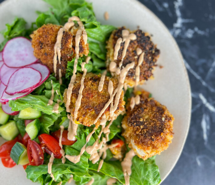 crab cakes on a salad with radishes rr