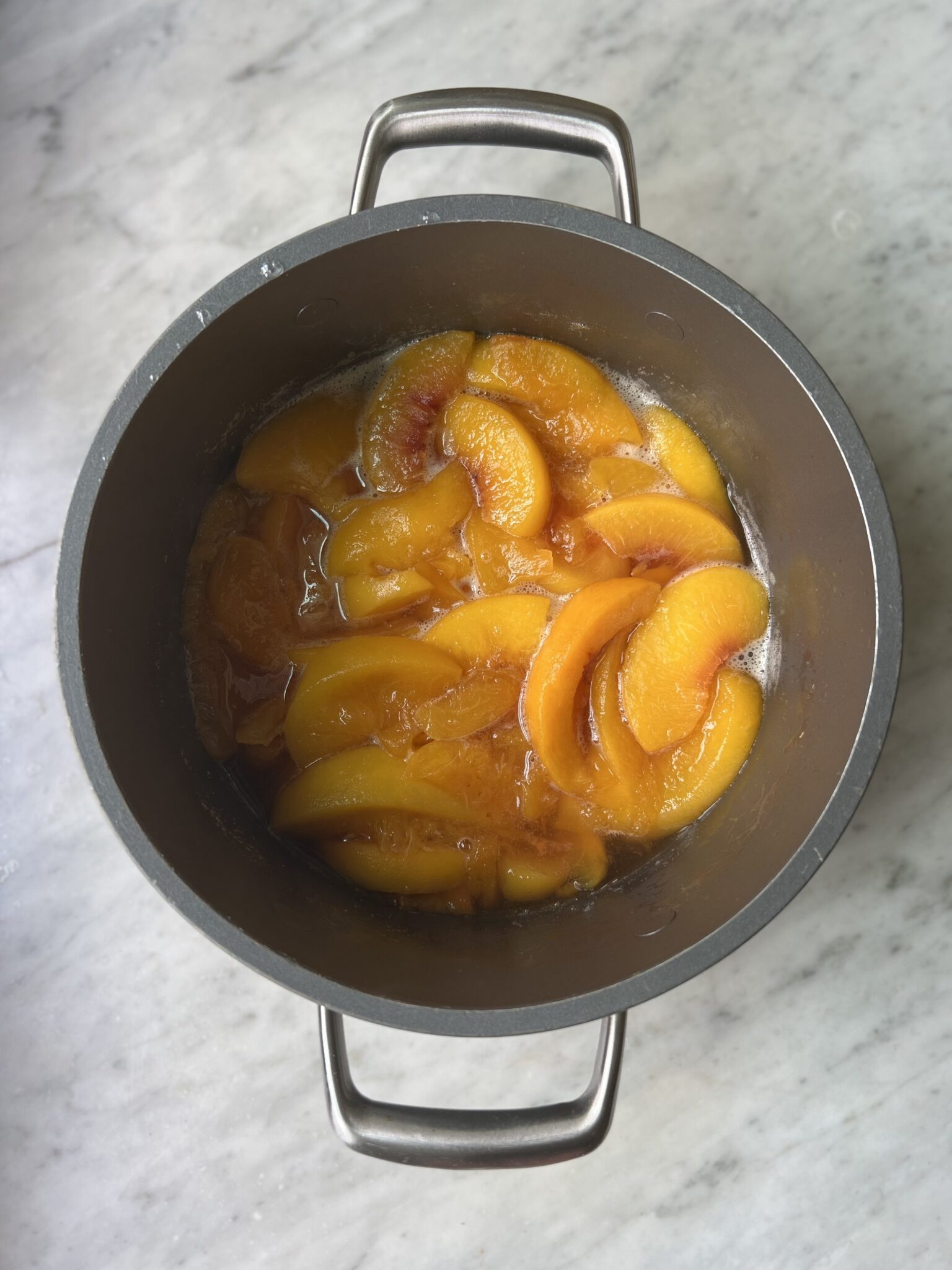 cooked peaches in a pot