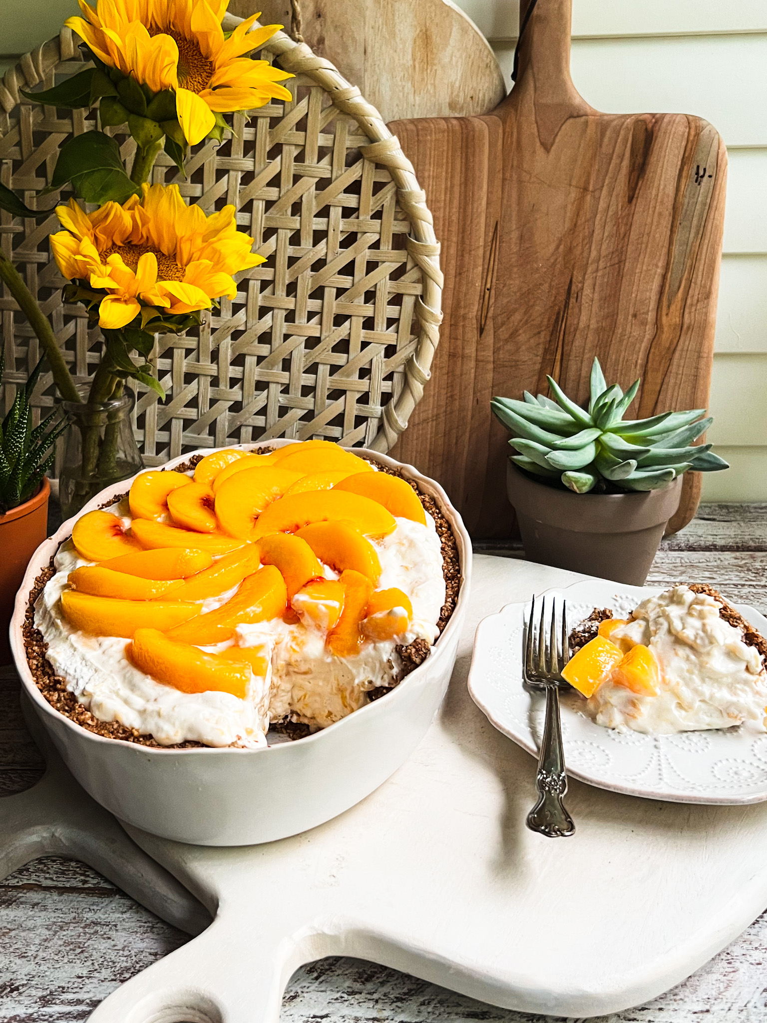 peaches-n-cream dessert with a piece on a plate with a fork