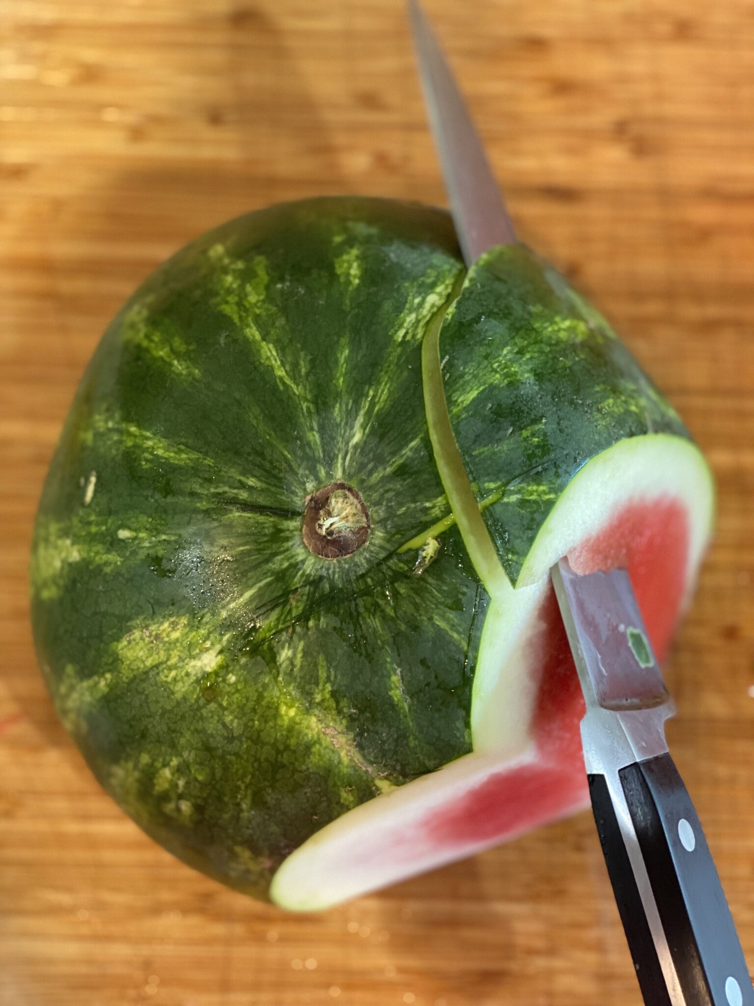 watermelon with a knife slicing it