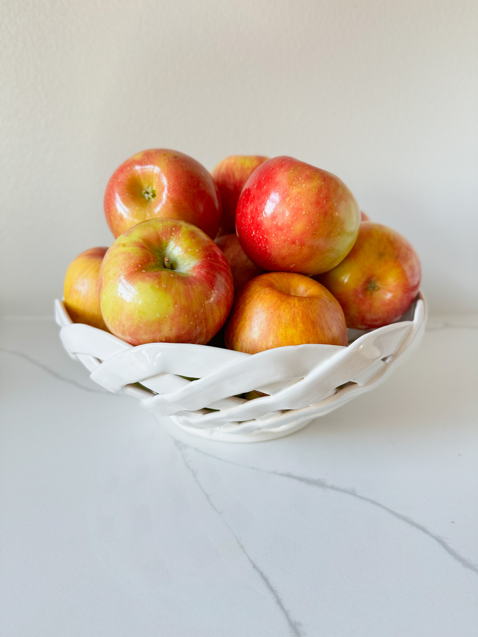 red apples in a white bowl