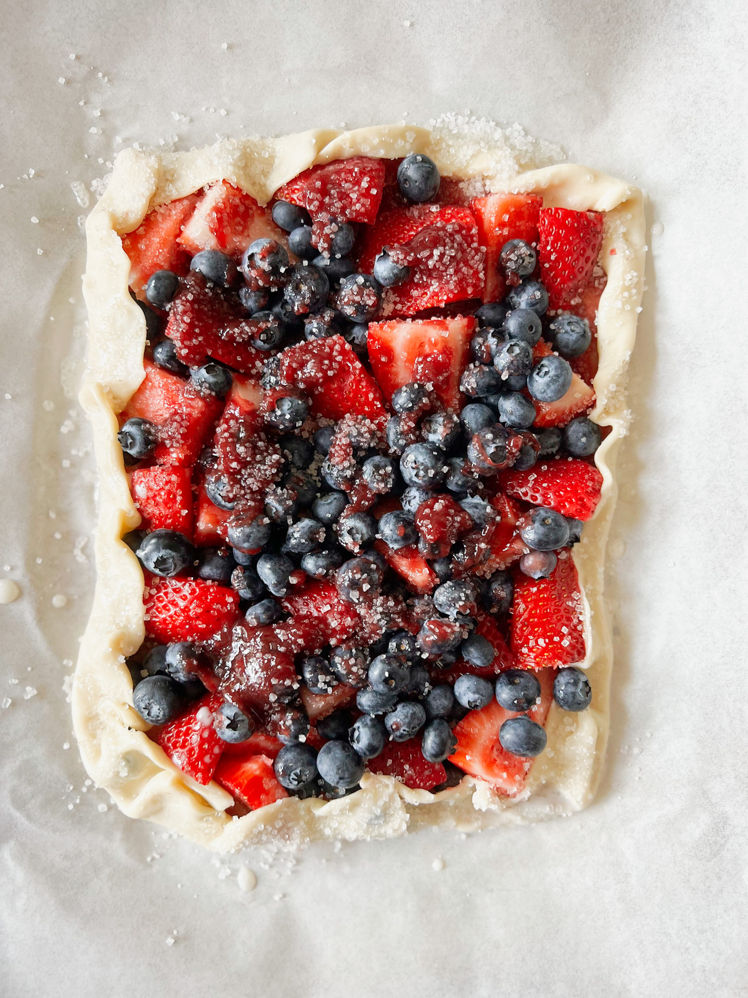 unbaked vegan fruit tart with blueberries and strawberries