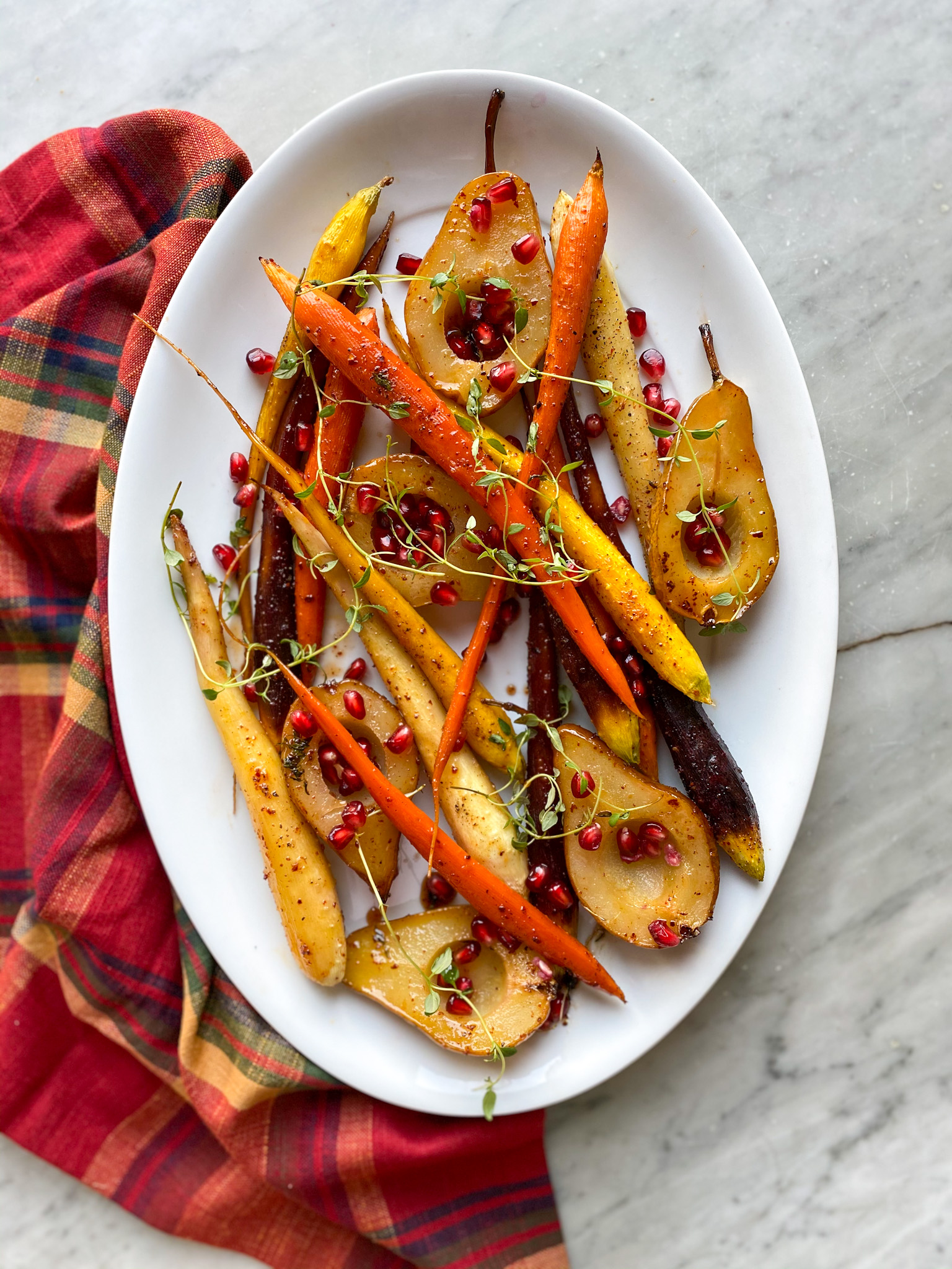 vegatable side dishes: carrots and pears on a platter with plaid napkin
