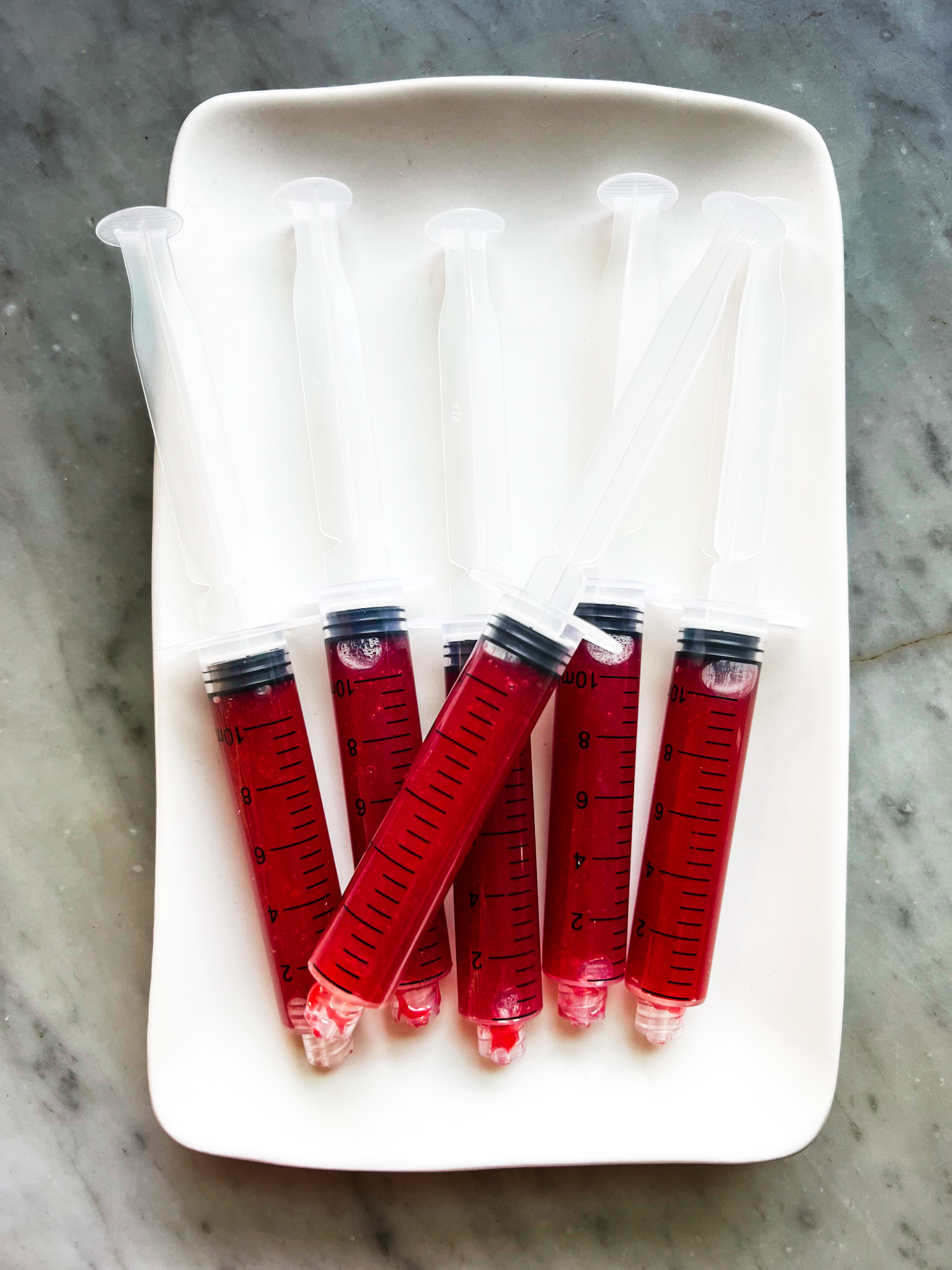 Syringes filled with raspberry shots