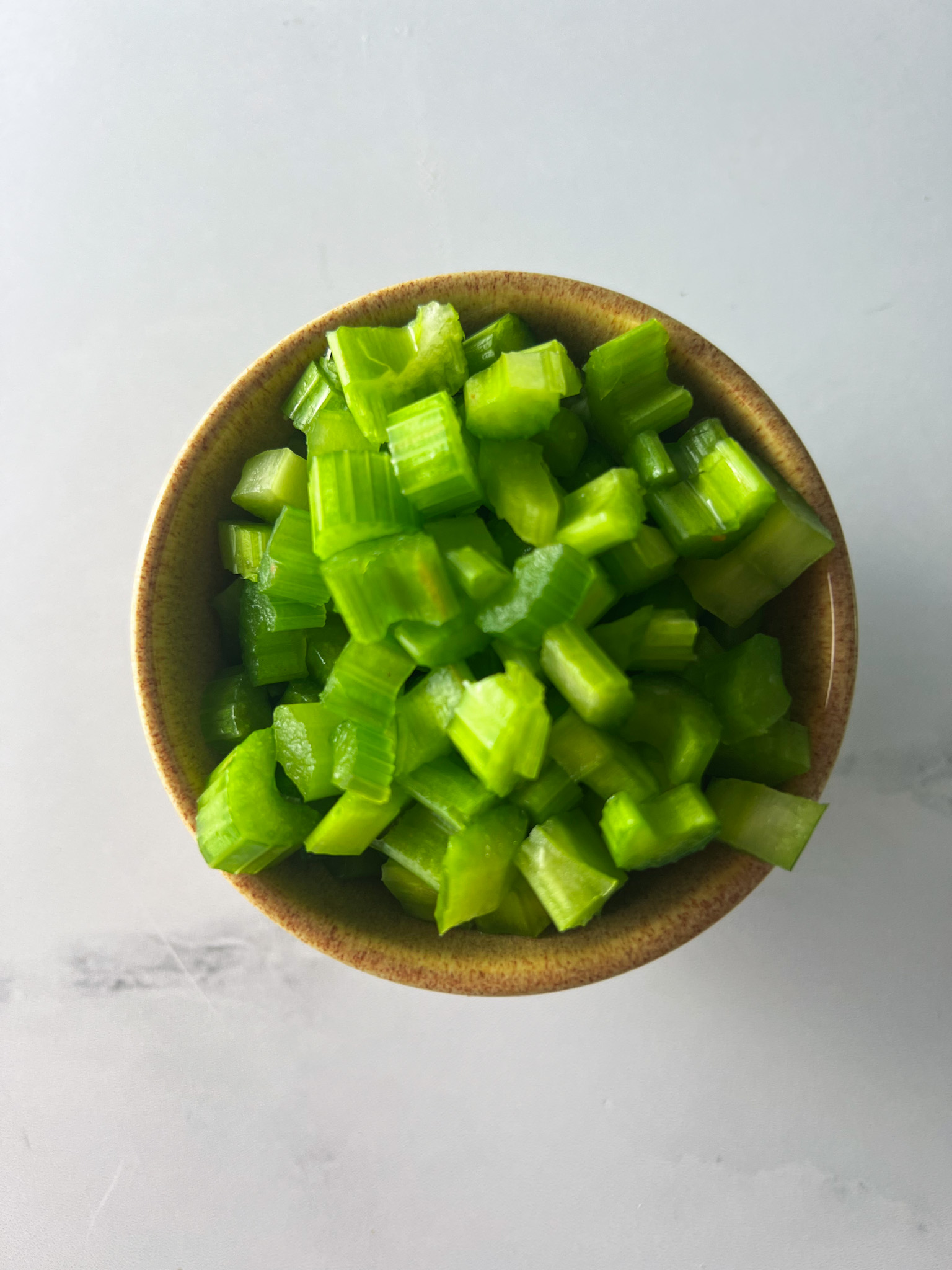 chopped celery in a bowl