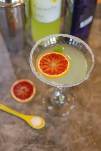 limoncello-martini in a glass with a blood orange slice floating in it