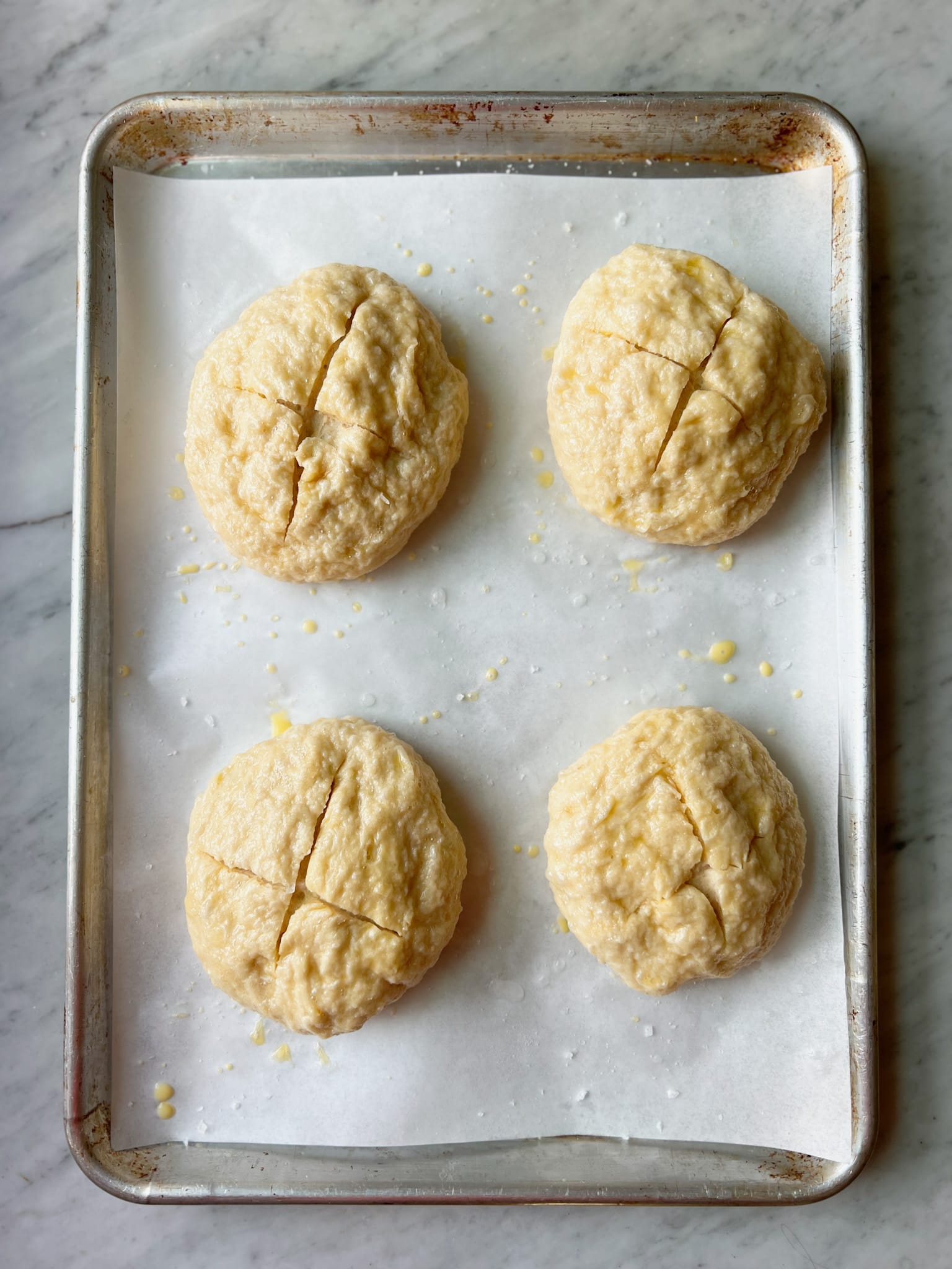 German pretzel buns on parchment after boil