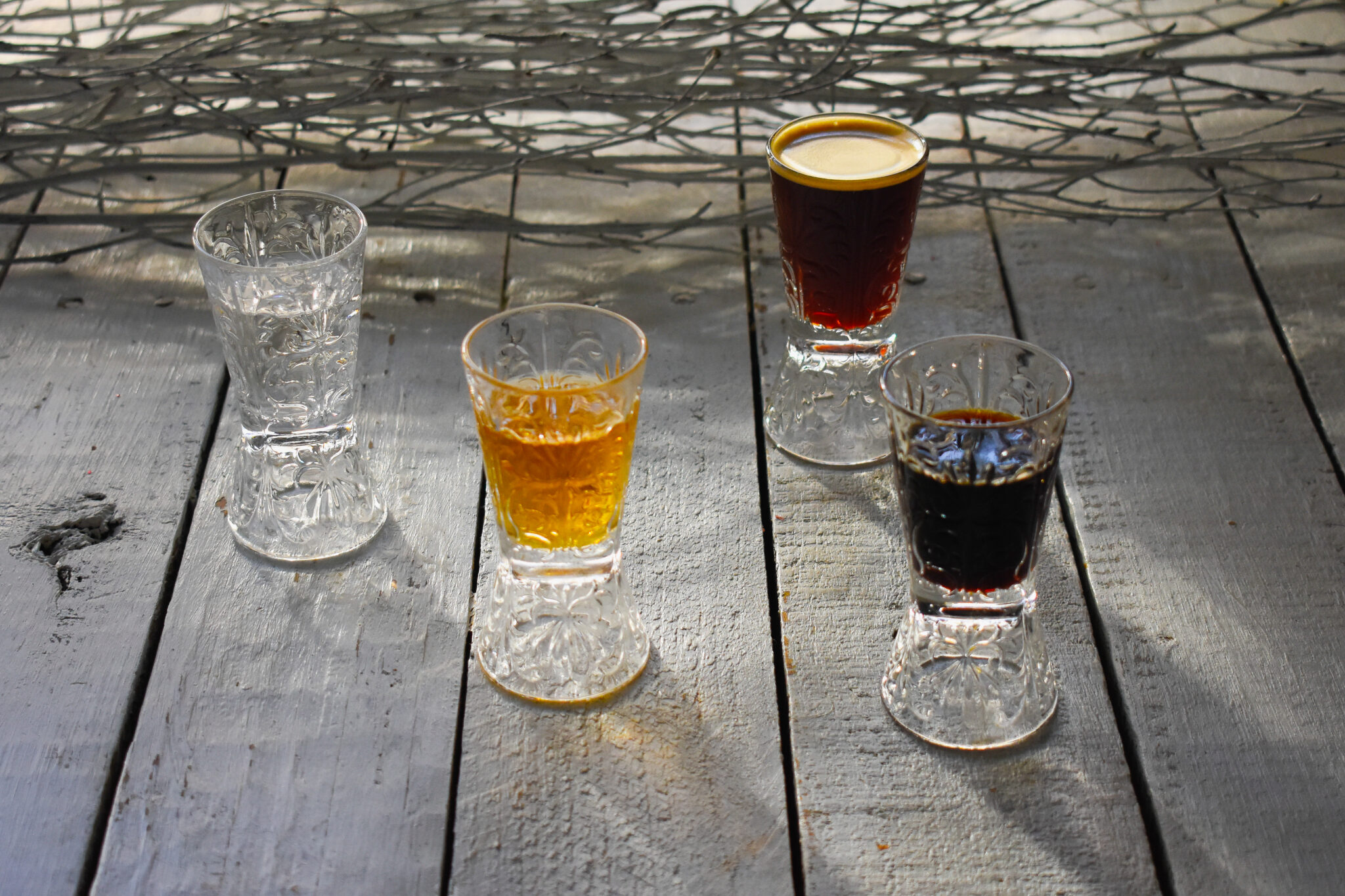 Shot glasses of vodka, frangelica, Kahlua and espresso ready for an espresso martini