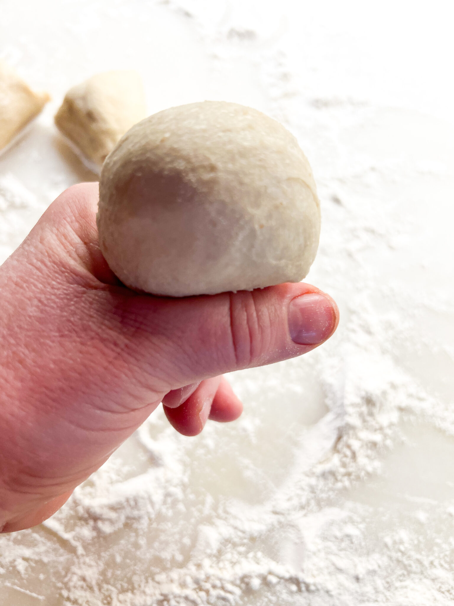 Squeezing the bread dough through the fingers