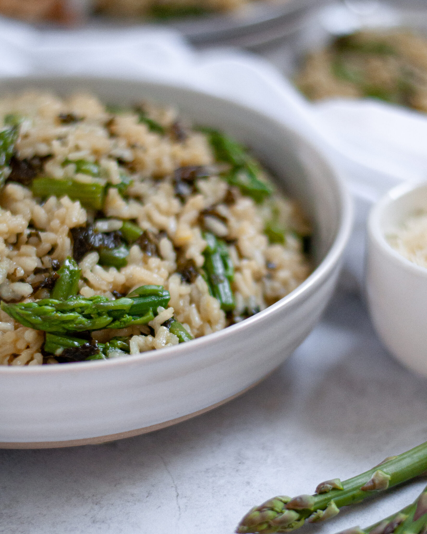 a bowl of summer veggie risotto with asparagus