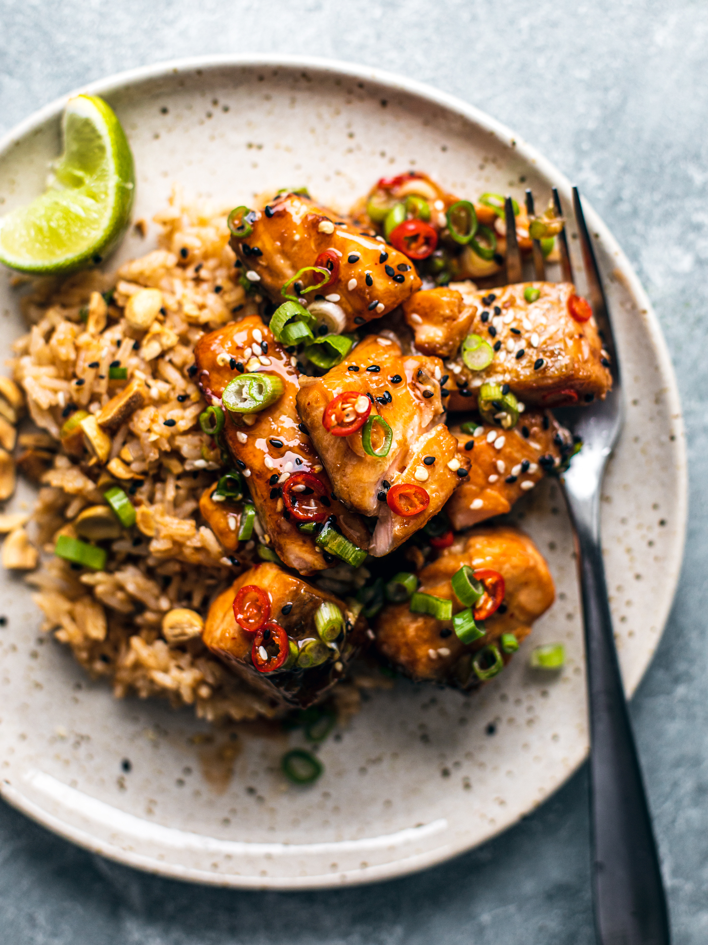 Thai sweet chili air fryer salmon bites on a plate with a fork and lime